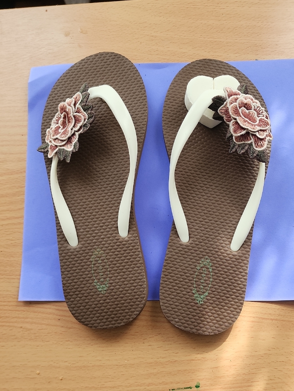 Women’s Brown Floral Appliqué Flip Flop Sandals with Cream Straps.